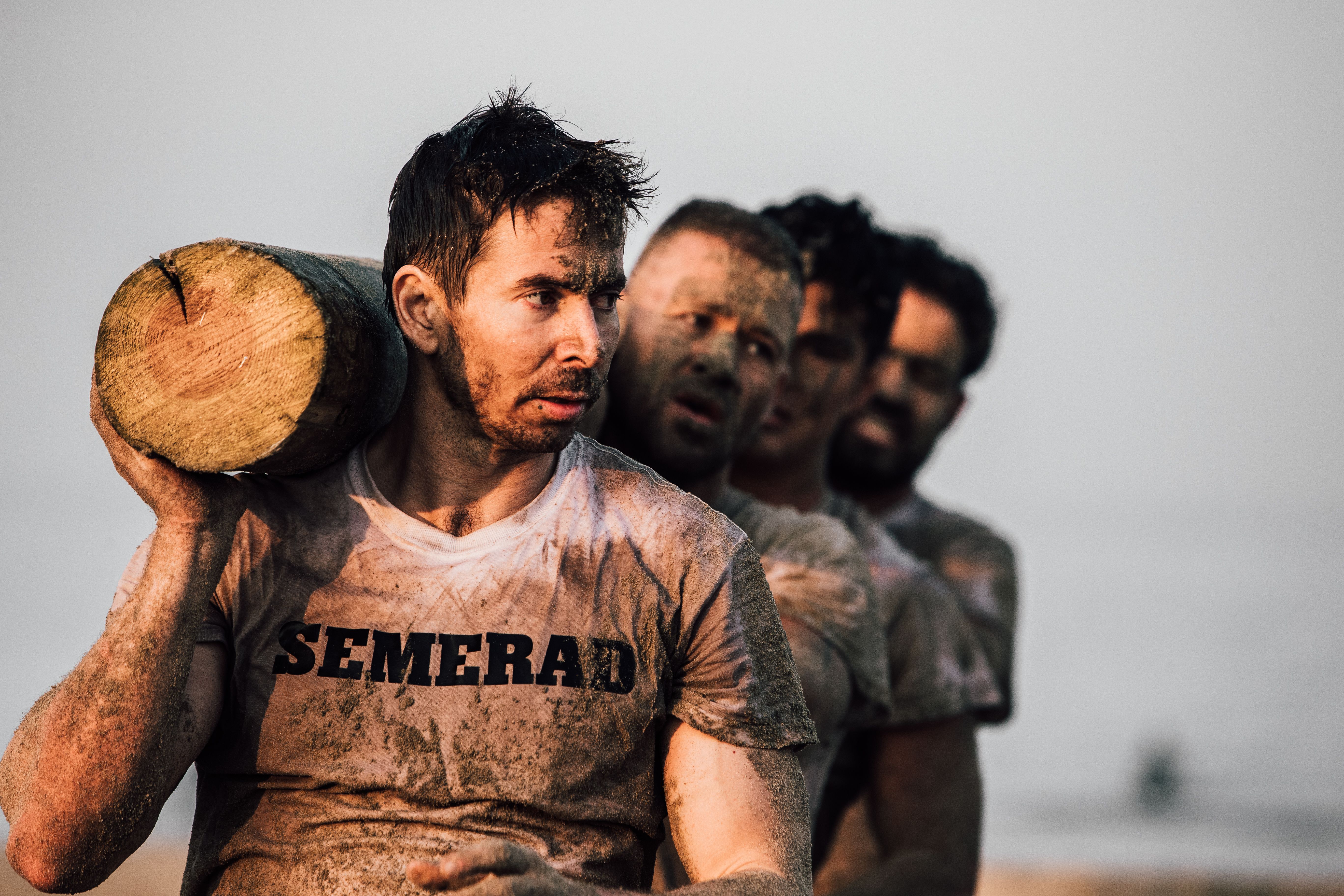 David Semerad carrying a log during an endurance challenge